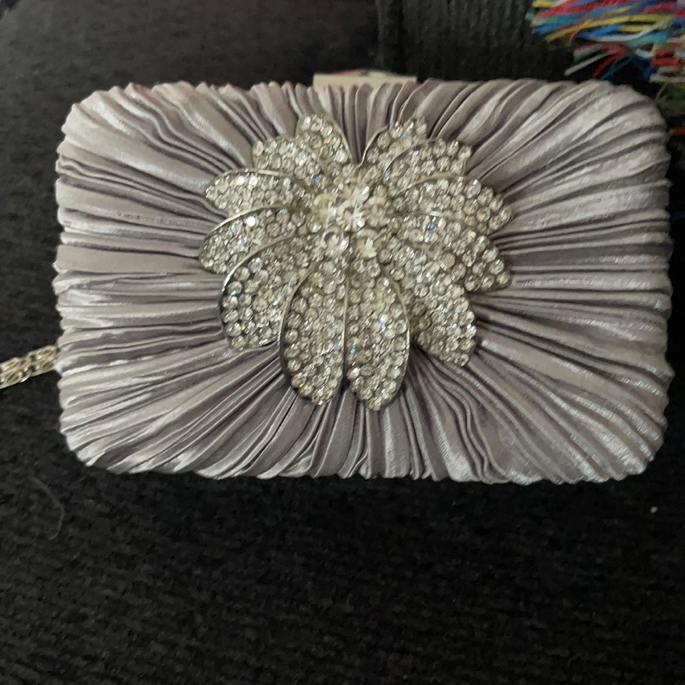 Beautiful silver clutch bag with pendant.